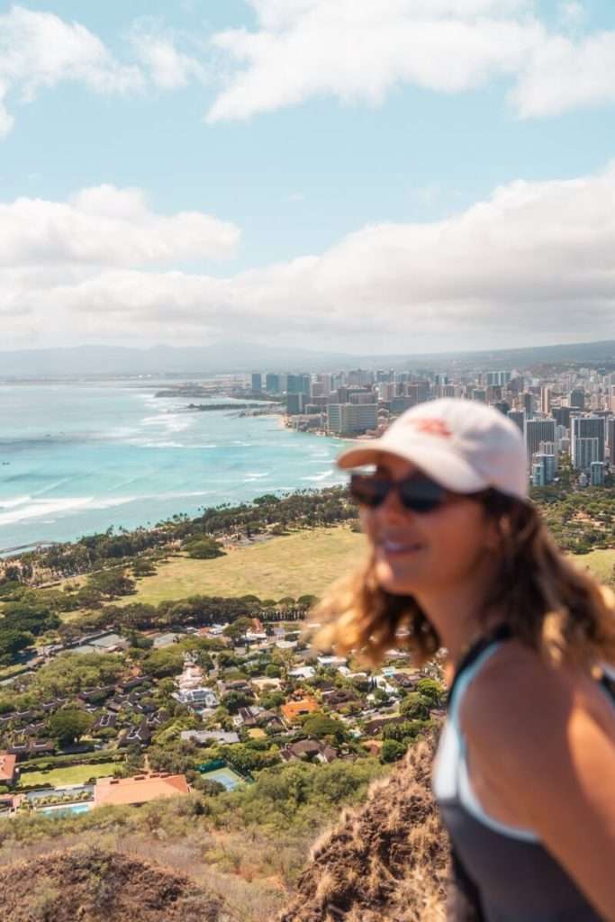 female hiker in a baseball cap on hawaii diamond head hike